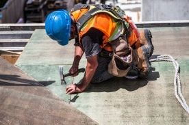 construction worker with hammer on work site.