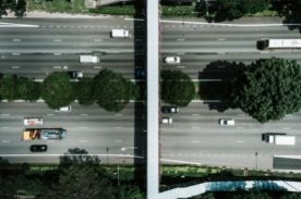 aerial view of a highway lined with trees.