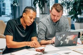 coworkers training with laptop.