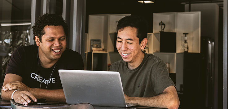 coworkers training with laptop.