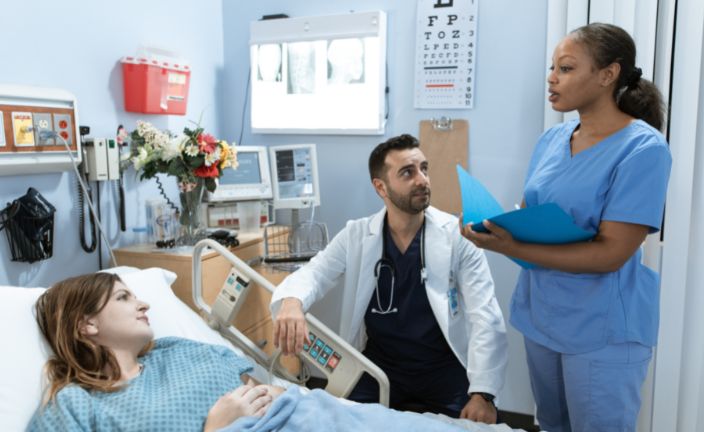 doctor and nurse at patient bedside.