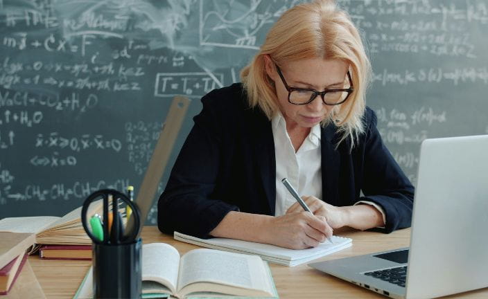 teacher working at a desk.