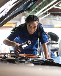 Auto Repair technician performing diagnostics on a vehicle.