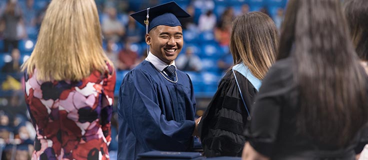 Penn Foster Graduate receiving their diploma.
