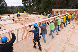 Construction workers installing a foundational wall.