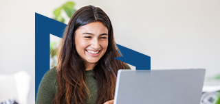Girl smiling and studying on laptop.