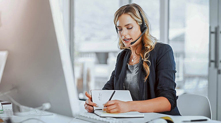 administrative assistant talks on headset.