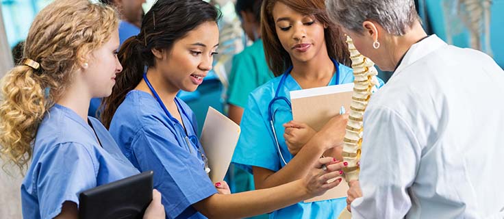 medical students and teacher in a lab.