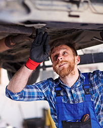 two mechanics inspect truck engine.