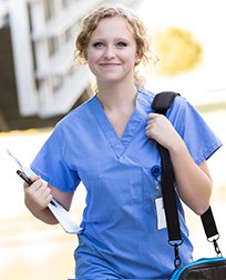healthcare professional walking with charts.