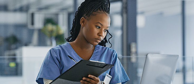 Healthcare administrator taking notes on an Ipad.