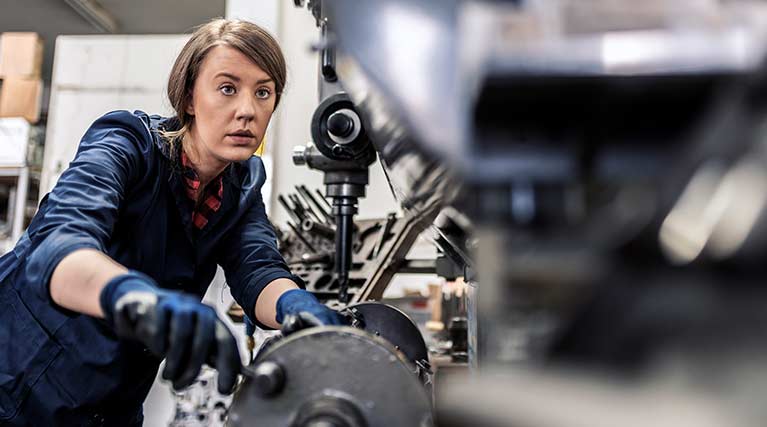 Machinist repairing a manufacturing machine.