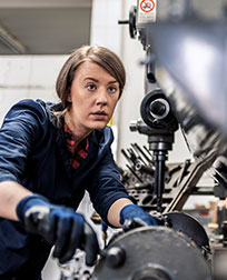 Machinist repairing a manufacturing machine.