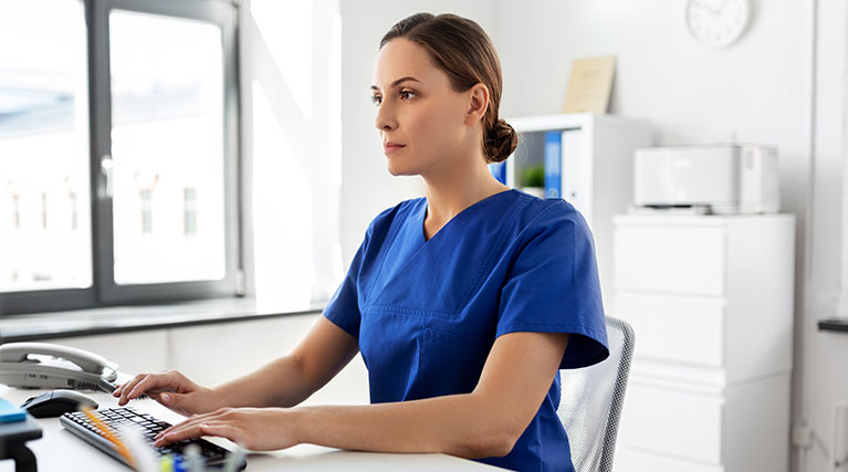 medical professional at computer.
