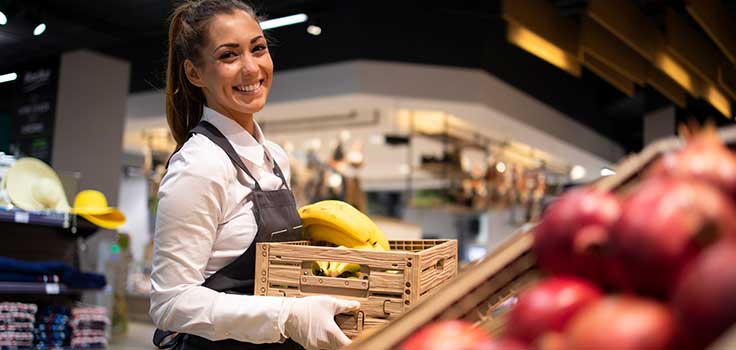 woman carrying a crate of fruit.